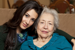 caregiver hugging old patient